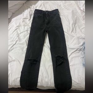 Black American Eagle jeans with rips in the knees.